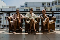 three women sitting on a balcony